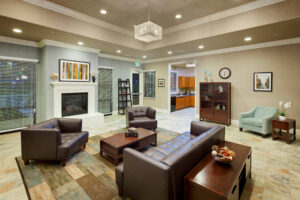 large community room with lounge areas and fireplace