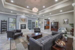 clubhouse interior, contemporary space, lounge seating, stone tiling, neutral toned, well lit, conference table.