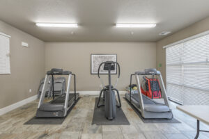fitness room, two treadmills and an elliptical machine.